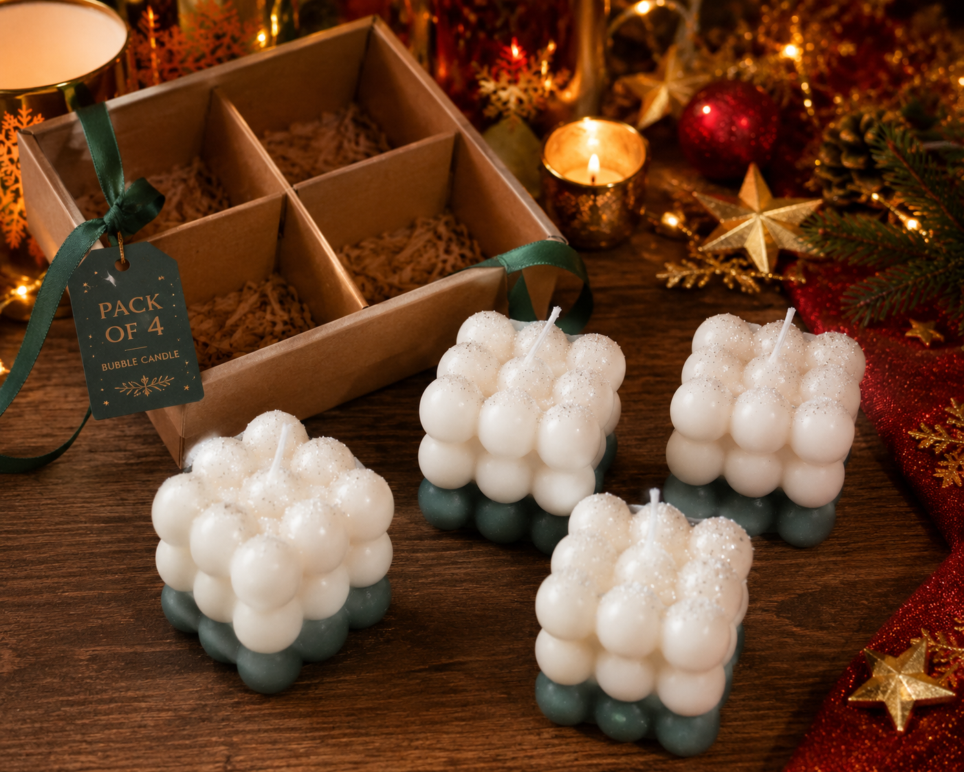 Four bubble candle decorations on a wooden surface with a box of candles and Christmas decor in the background.