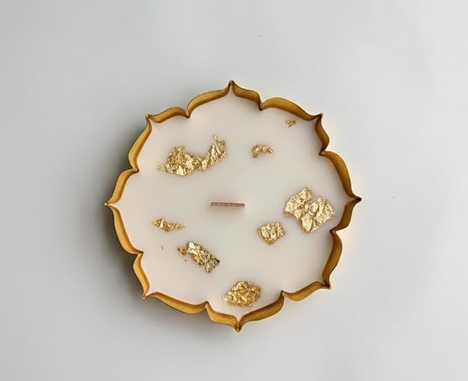 Decorative plate with gold embellishments on a light gray background