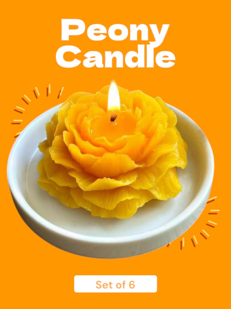 A yellow peony scented candle in the shape of a flower, set on a white plate with a bright orange background. The product is sold in a set of 6.