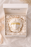 Decorative item in a 'Sorcish' box on a soft fabric background